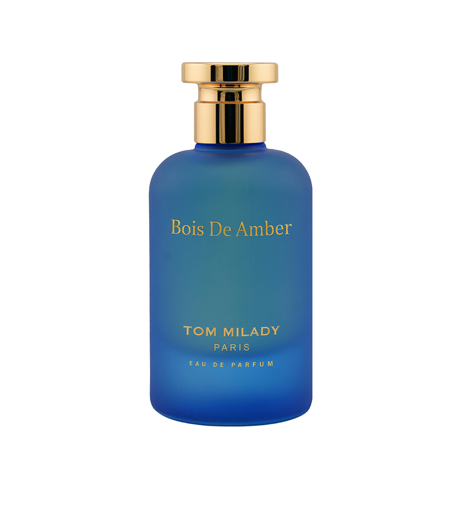 Woman confidently wearing bespoke citrus-amber signature scent, Luxury unboxing experience of limited-edition fragrance.